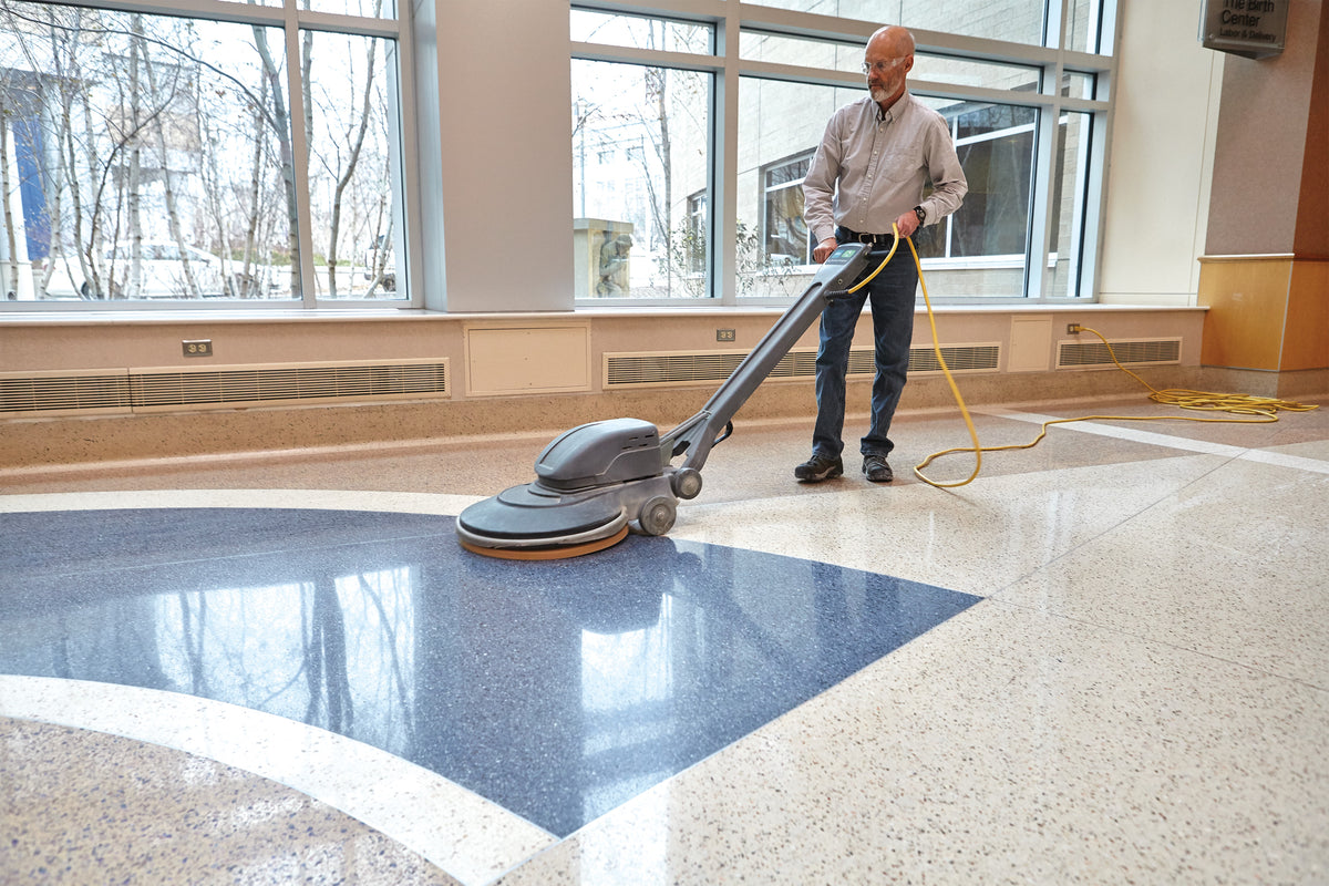 Floor being buffed with a red pad